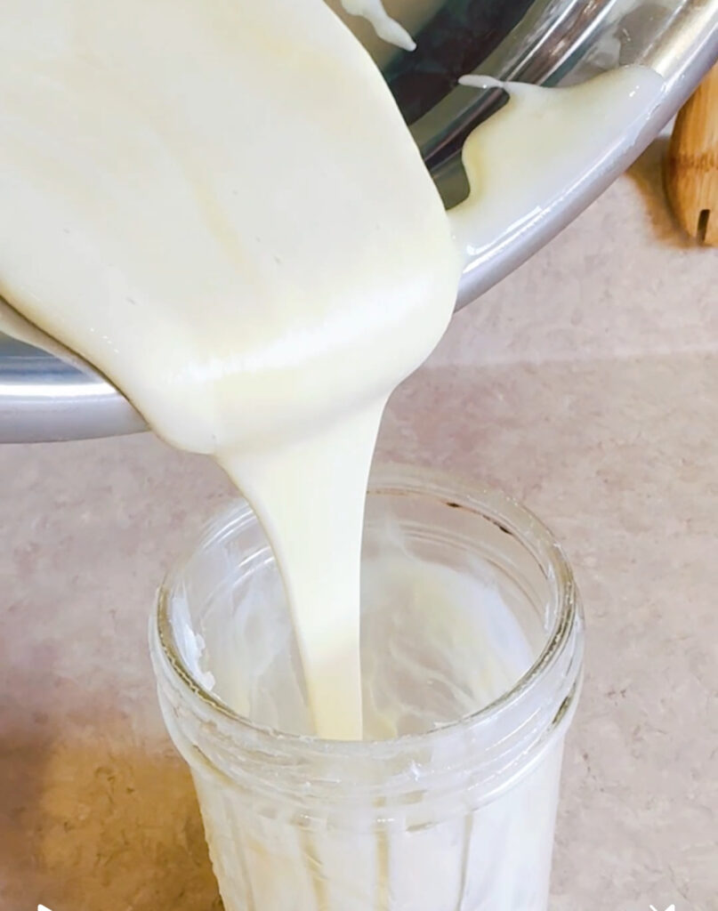 A glass of milk being poured into it.