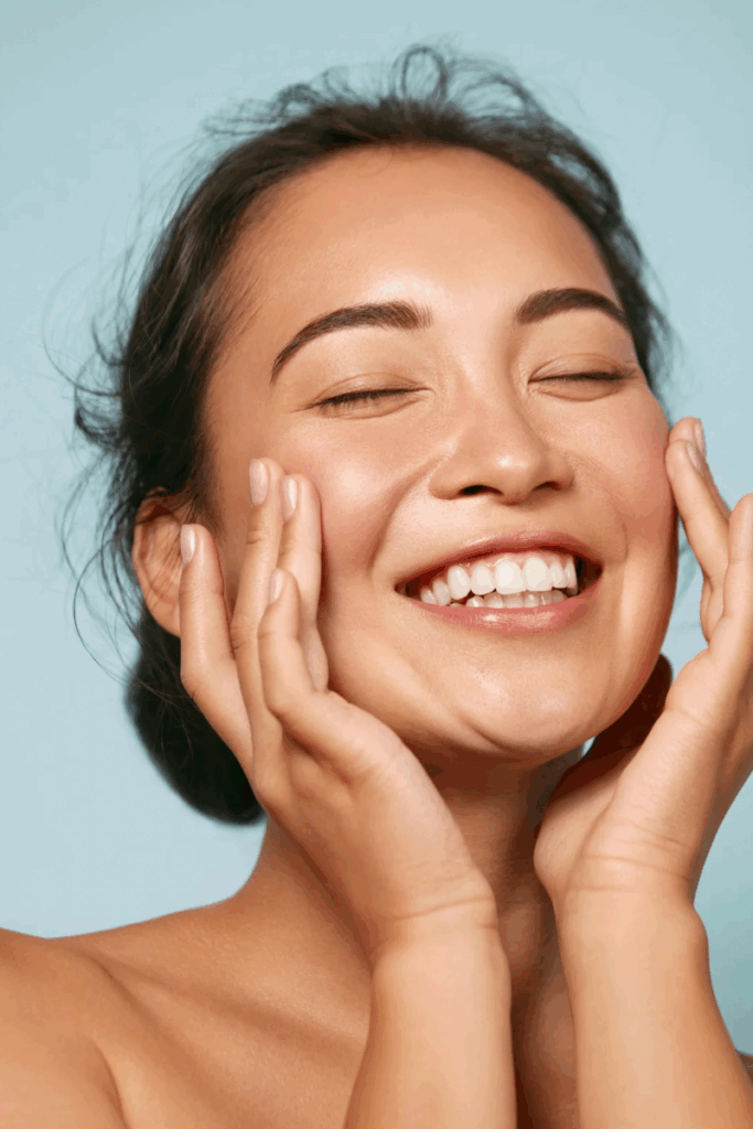 A woman with her hands on her face.